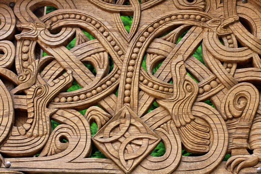 Norse Mythology Creatures: Kin and Killers of the Gods Intricate wooden carving with intertwined animal forms, looping serpents and a central knot.