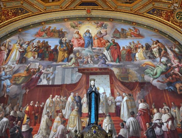 Reading Famous Religious Paintings Through Gesture Religious fresco with angels and gathered figures beneath an ornate gilded arch in the Vatican's Raphael Rooms.